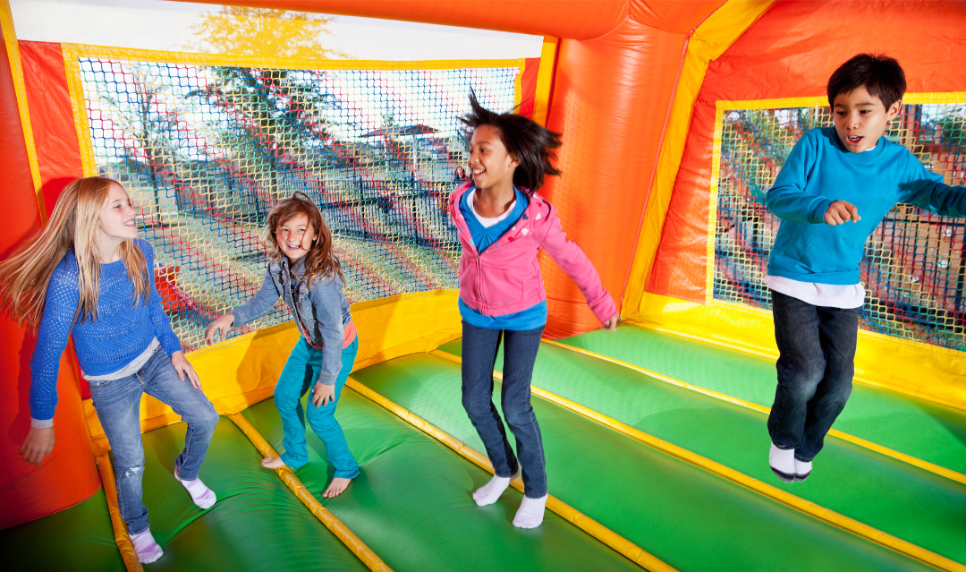 kids bouncing in bounce house for birthday party