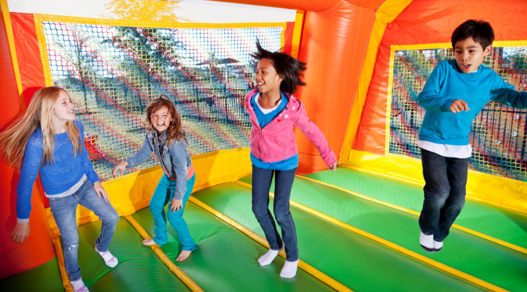 kids bouncing in bounce house for birthday party
