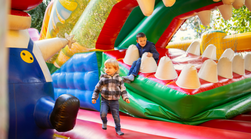 kids on inflatable bounce house course